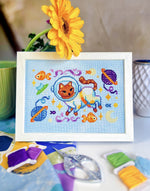 Catstronaut cross stitch pattern by NeedleLot Designs, a cat in a space suit