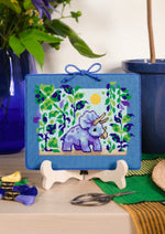 Triceratops cross stitch pattern by NeedleLot Designs, a triceratops in a prehistoric jungle