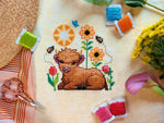 Wee Highland Calf cross stitch pattern by NeedleLot Designs, a highland calf among flowers