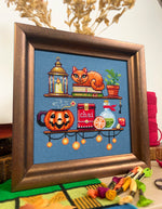 Cozy Autumn Shelves cross stitch pattern by NeedleLot Designs, shelves with books, a cat, candle, pumpkin and mushroom
