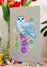 Snowy Owl cross stitch pattern by NeedleLot Designs, a snowy owl on a purple stump