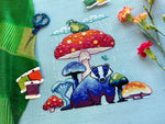 Mushroom Badger cross stitch pattern by NeedleLot Designs, a badger under a toadstool