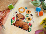 Wee Highland Calf cross stitch pattern by NeedleLot Designs, a highland calf among flowers