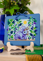 Triceratops cross stitch pattern by NeedleLot Designs, a triceratops in a prehistoric jungle