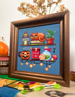 Cozy Autumn Shelves cross stitch pattern by NeedleLot Designs, shelves with books, a cat, candle, pumpkin and mushroom