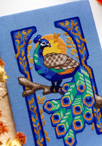 Art Nouveau Peacock cross stitch pattern by NeedleLot Designs, a peacock in an Art Nouveau frame