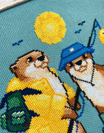 Fishing Buddies cross stitch pattern by NeedleLot Designs, two otters fishing