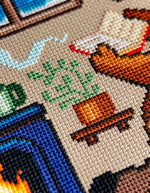 Reading by the Fire cross stitch pattern by NeedleLot Designs, a bear reading by the fire