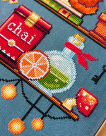 Cozy Autumn Shelves cross stitch pattern by NeedleLot Designs, shelves with books, a cat, candle, pumpkin and mushroom