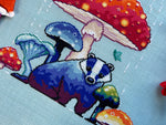 Mushroom Badger cross stitch pattern by NeedleLot Designs, a badger under a toadstool