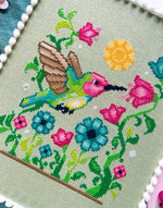 Hummingbird cross stitch pattern by NeedleLot Designs, a hummingbird among flowers