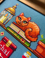 Cozy Autumn Shelves cross stitch pattern by NeedleLot Designs, shelves with books, a cat, candle, pumpkin and mushroom